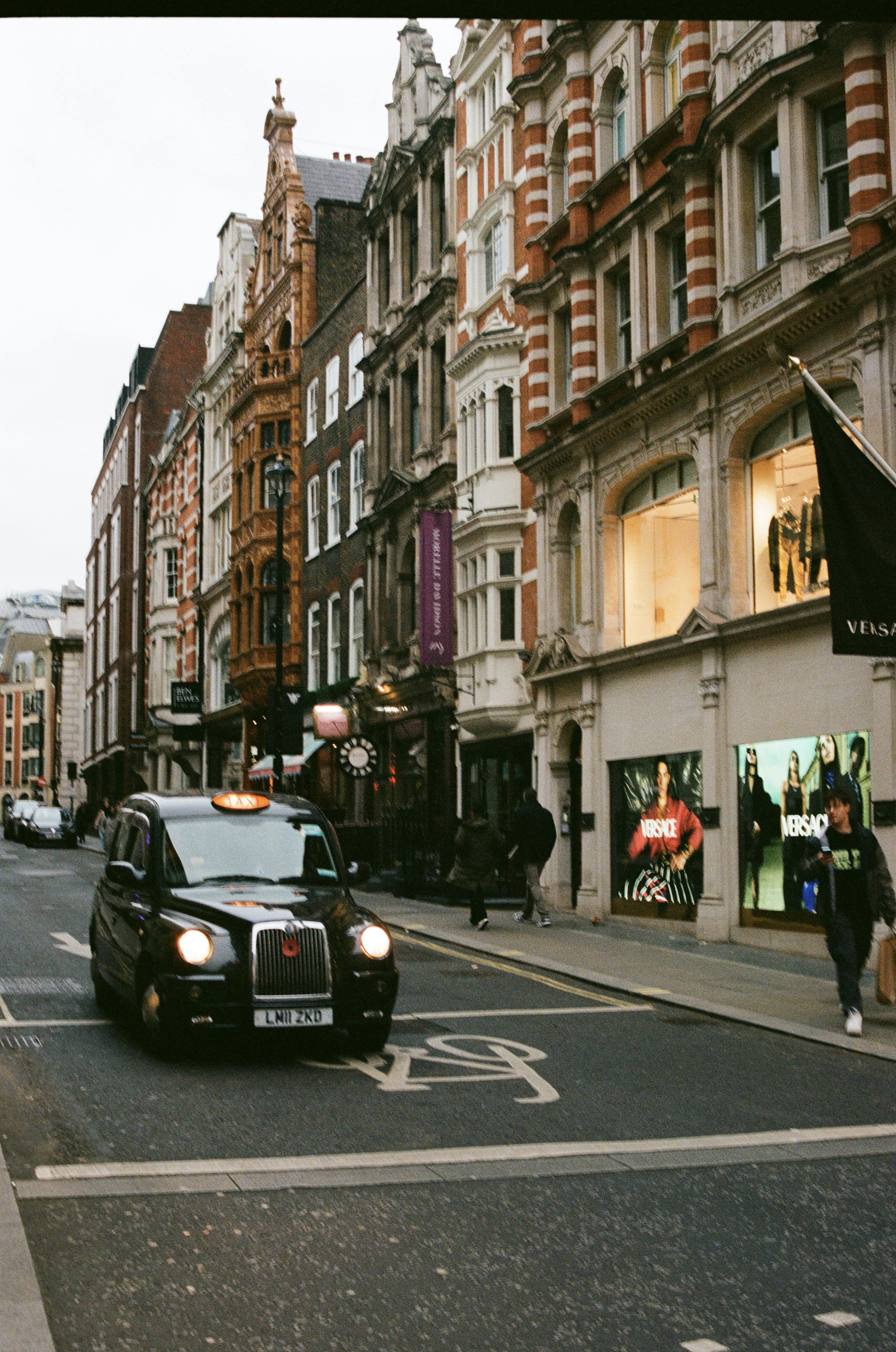 Black taxi cab driving through the streets in London