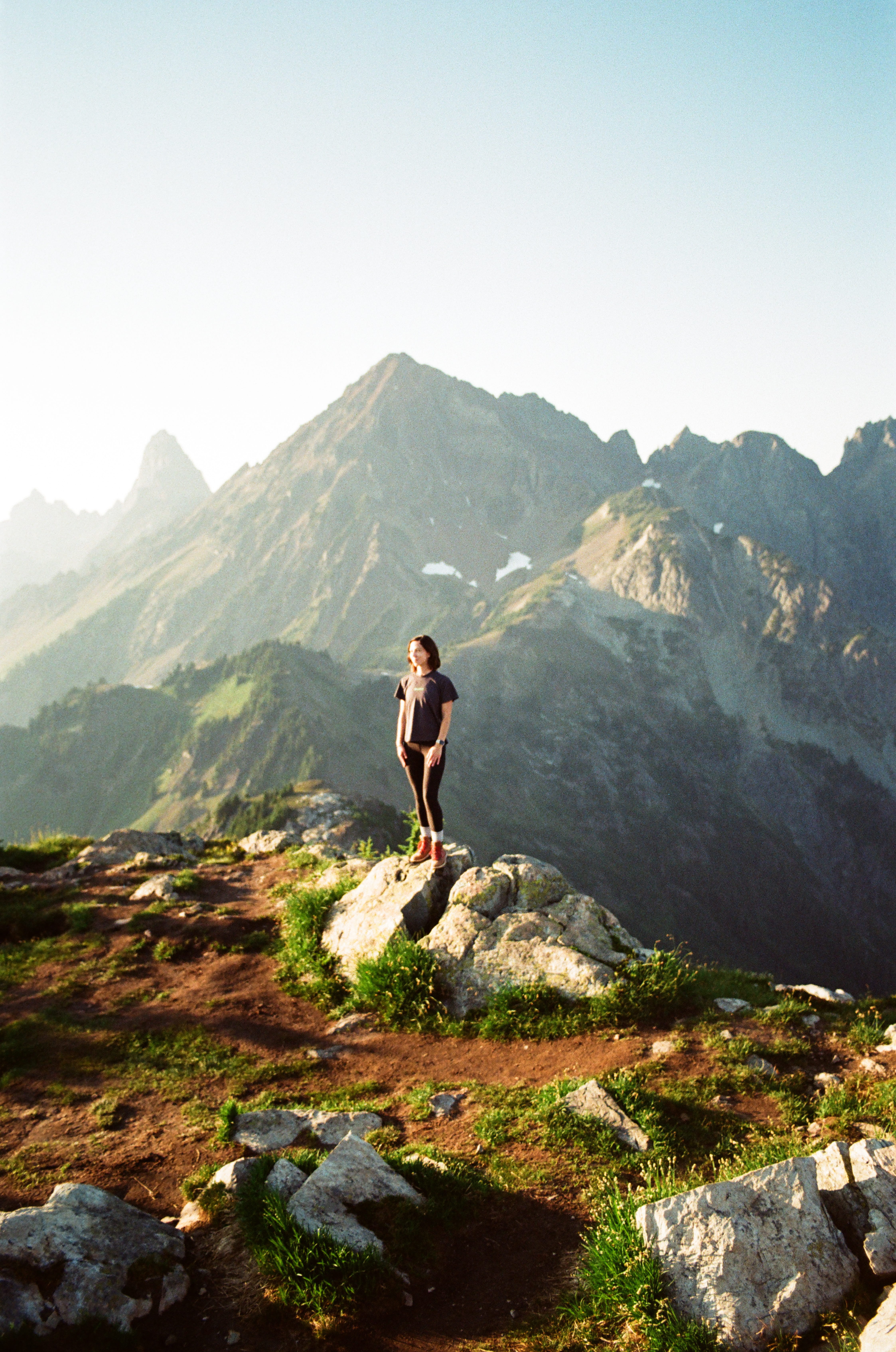 Woman standing on a mountain trail in the North Cascades, Washington